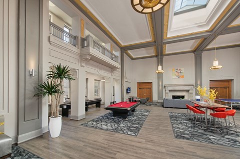 a large living room with a red pool table
